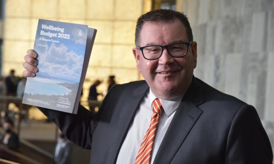 New Zealand finance minister Grant Robertson holds up a copy of the 2022 budget.