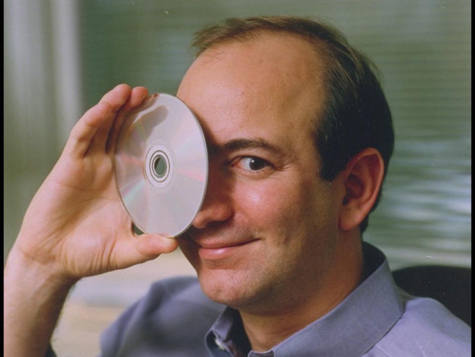 Jeff Bezos hold CD up to his eye