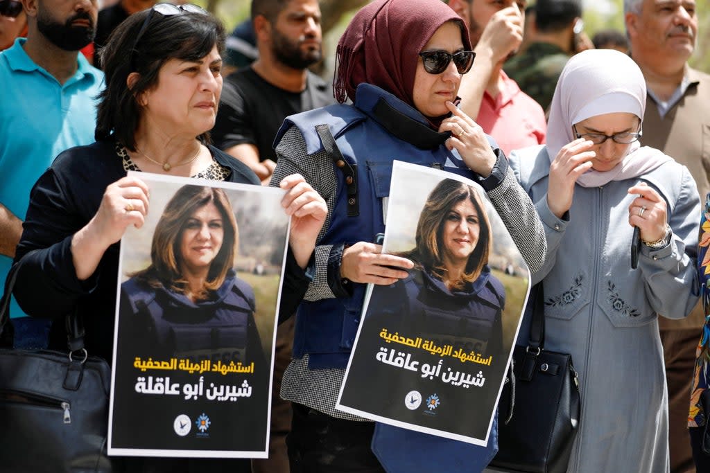 Palestinians hold pictures of Al Jazeera reporter Shireen Abu Akleh, who was killed by Israeli army gunfire during an Israeli raid, according to the Qatar-based news channel, in the West Bank (Reuters)
