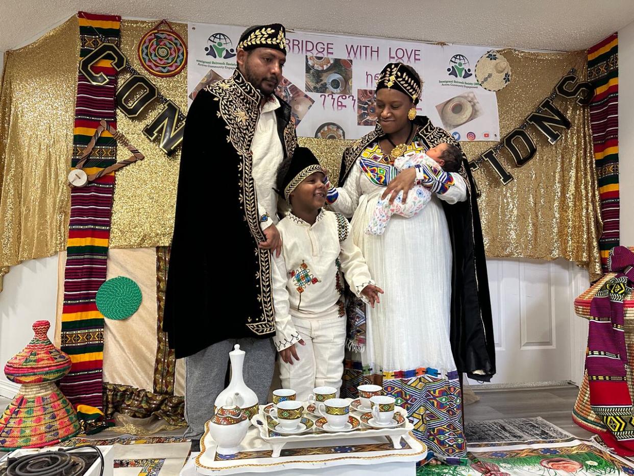 Gold banners and traditional artifacts fill the small basement suite in northeast Calgary to provide a feeling of home for mother Ruhama Alemu, her baby Yohana and the rest her family. (Elise Stolte/CBC - image credit)