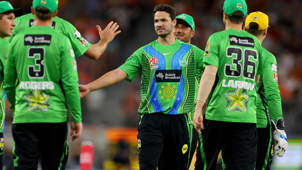Nathan Coulter-Nile is congratulated by Melbourne Stars teammates after taking a wicket in the BBL.