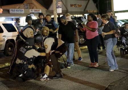 Police detain a protester in Ferguson, Missouri, August, 10, 2015.REUTERS/Rick Wilking