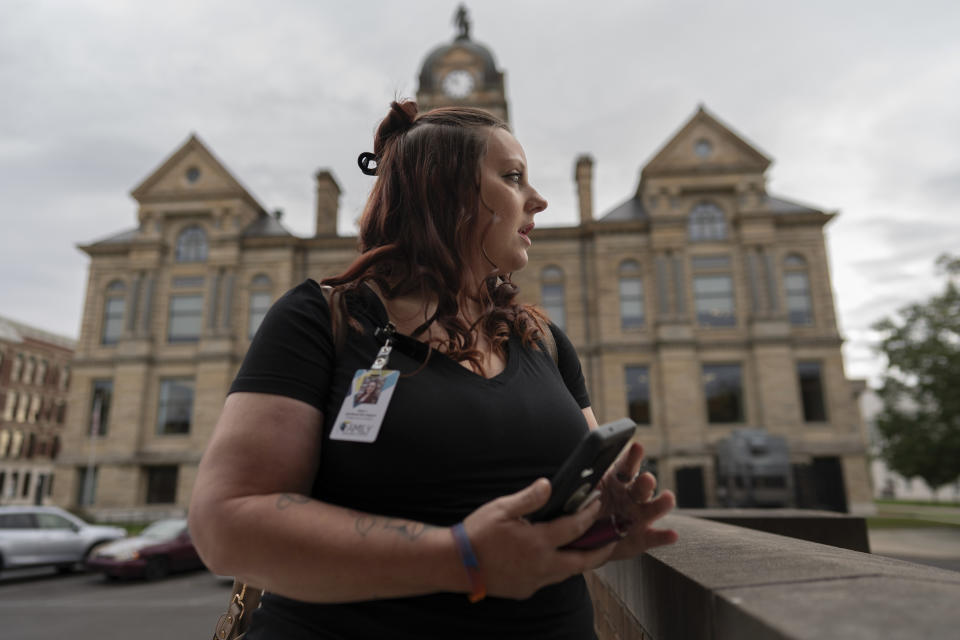 Jesse Johnson of the Family Resource Center waits for a client at Hancock County Probate/Juvenile Court in Findlay, Ohio, Thursday, Oct. 12, 2023. Johnson accompanies clients in recovery to court appearances and gives them rides to key appointments in her peer recovery job, just as a worker at the same organization did for her. (AP Photo/Carolyn Kaster)