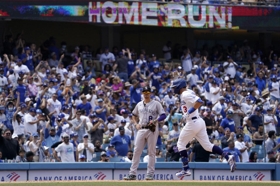 Los Angeles Dodgers' Chris Taylor, right, heads to third after hitting a solo home run as Colorado Rockies third baseman Joshua Fuentes watches during the fifth inning of a baseball game Sunday, July 25, 2021, in Los Angeles. (AP Photo/Mark J. Terrill)
