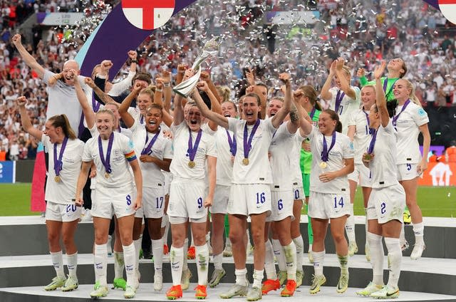 England’s Ellen White and Jill Scott lift the trophy after England won Euro 2022