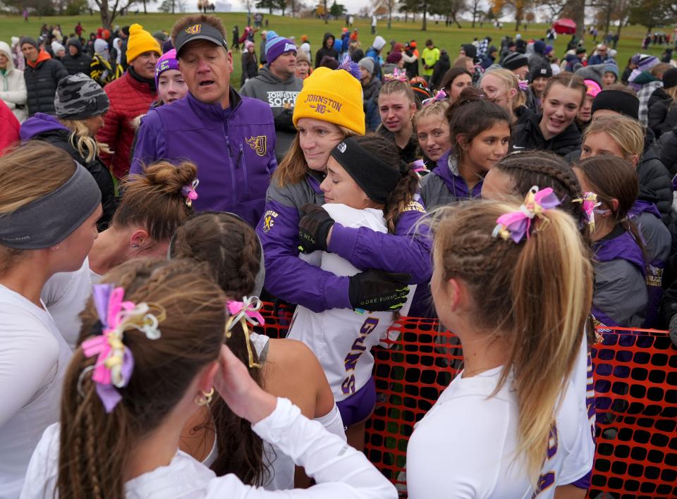 Johnston runners celebrate after Olivia Verde took second at the 4A state cross country meet Friday in Fort Dodge.
