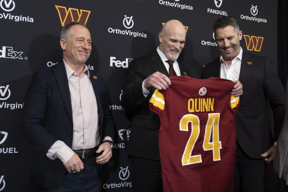 Washington Commanders new head coach Dan Quinn, center, holds a jersey as he stands with Commanders managing partner Josh Harris, left, and general manager Adam Peters, right, during an NFL football news conference at Commanders Park in Ashburn, Va., Monday, Feb. 5, 2024. (AP Photo/Manuel Balce Ceneta)