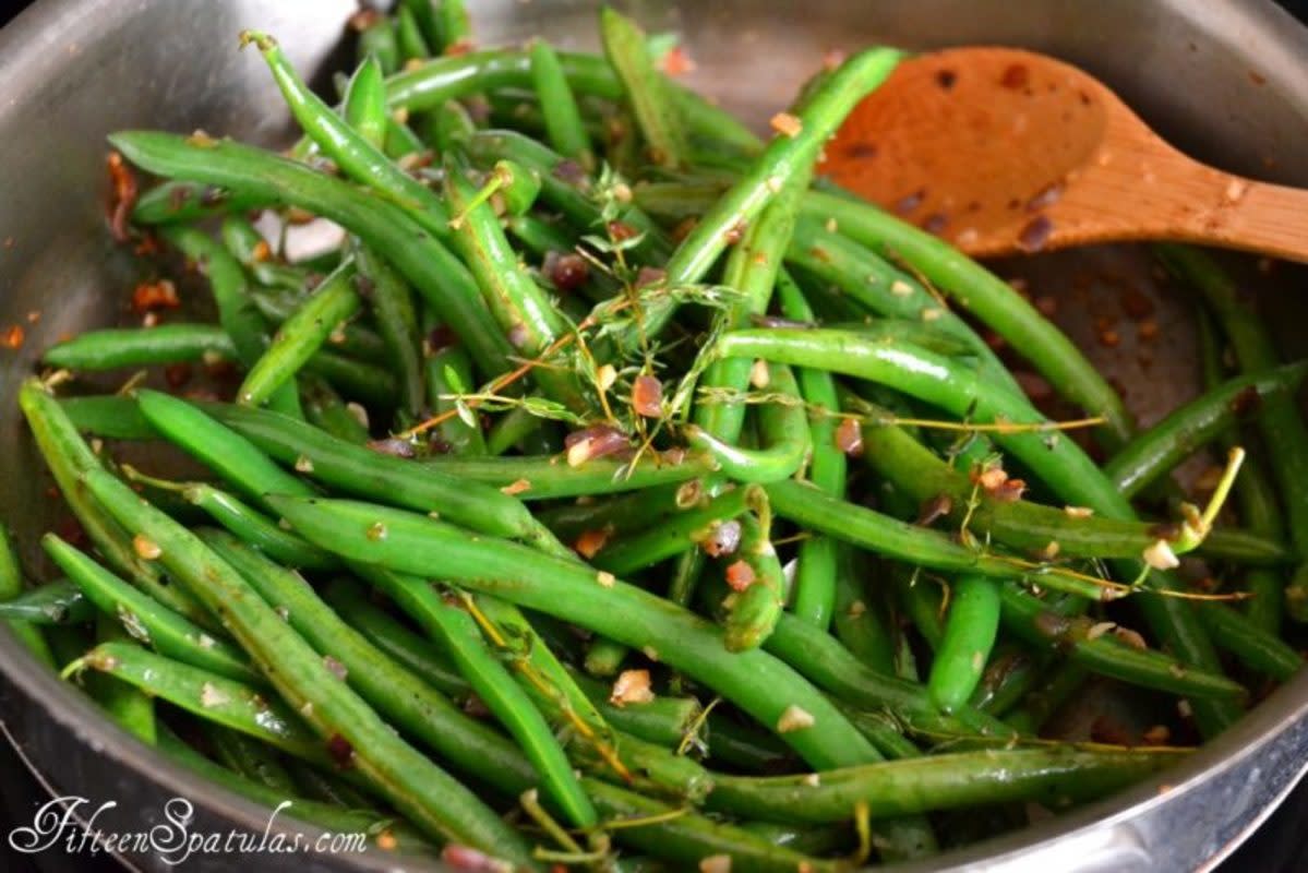 <p>Courtesy of fifteenspatulas.com</p><p>This simple green bean side dish is prepared with shallots, garlic and fresh thyme, for an easy and delicious vegetable with lots of flavor. It’s great for Thanksgiving or any weeknight dinner!</p><p><strong>Get the Recipe: <a href="https://www.fifteenspatulas.com/thanksgiving-prep-how-to-make-green-beans-sexy/" rel="nofollow noopener" target="_blank" data-ylk="slk:Thanksgiving Green Beans;elm:context_link;itc:0;sec:content-canvas" class="link rapid-noclick-resp">Thanksgiving Green Beans</a></strong></p><p><strong>Related: 100+ <a href="https://parade.com/944960/parade/thanksgiving-desserts/" rel="nofollow noopener" target="_blank" data-ylk="slk:Best Thanksgiving Desserts;elm:context_link;itc:0;sec:content-canvas" class="link rapid-noclick-resp">Best Thanksgiving Desserts</a></strong></p>
