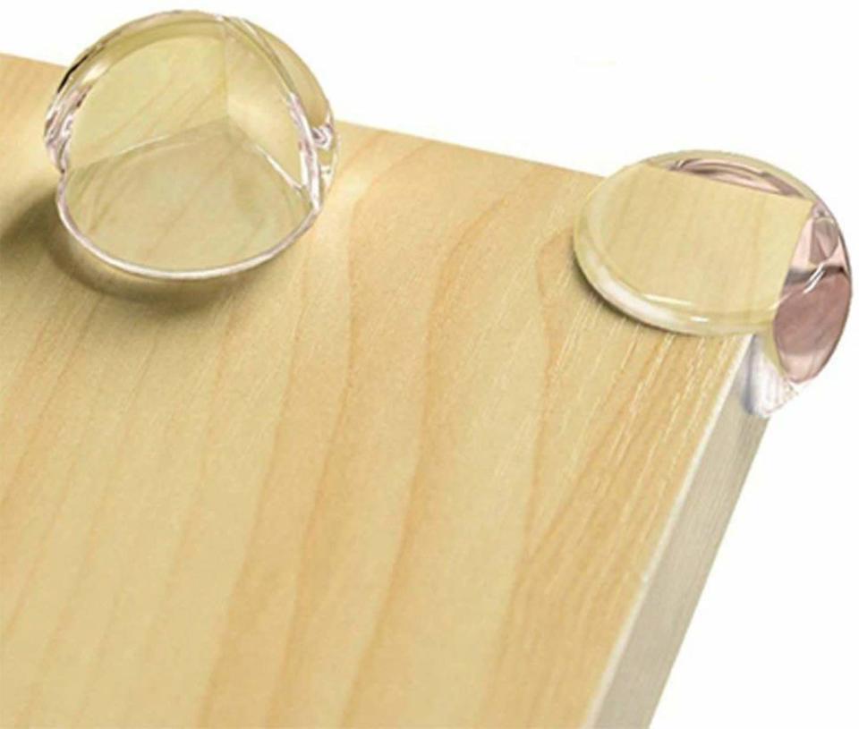 Clear corner protector on the edge of a wooden surface