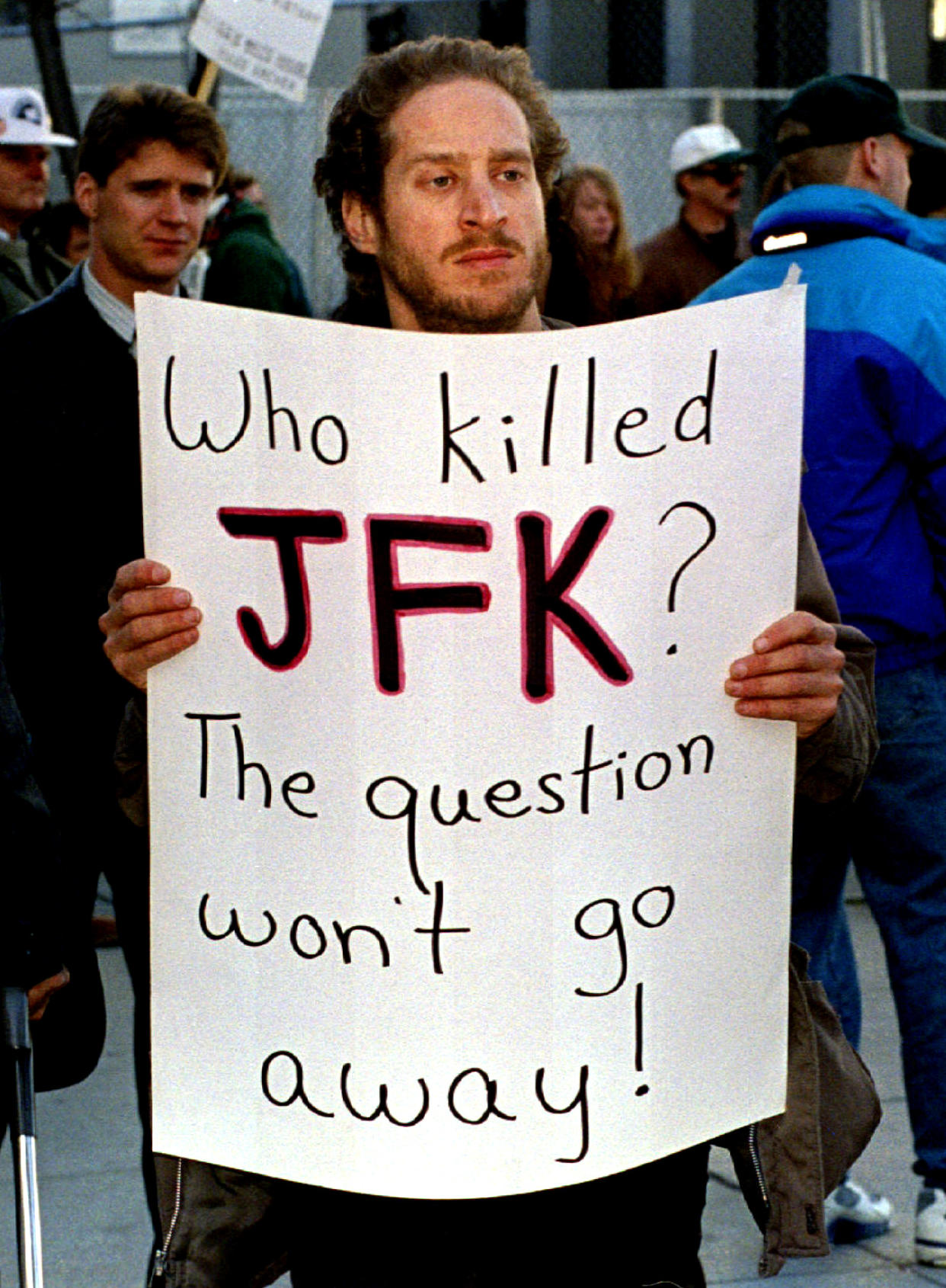 Bryan Tucker marches in a protest outside the John F. Kennedy Federal Building in Boston