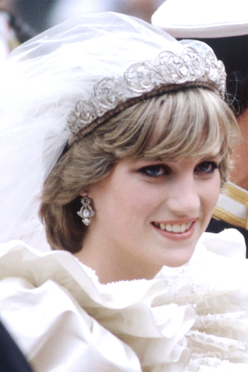 <p>For her wedding to Prince Charles, Diana sported more defined bangs while wearing a tiara and veil. </p>