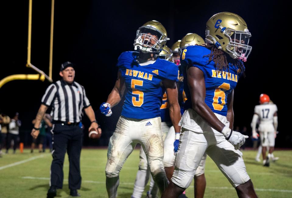 Cardinal Newman wide receiver Max Redmon, left, (5) celebrates his touchdown with Dallas Desouza, (6) against Benjamin during their football game on October 20, 2023 in West Palm Beach, Florida.