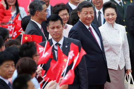 Chinese President Xi Jinping and his wife Peng Liyuan arrive at the airport in Hong Kong, China, ahead of celebrations marking the city's handover from British to Chinese rule, June 29, 2017. REUTERS/Bobby Yip