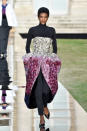 <p>Model wears a long-sleeve shirt and trousers underneath a dazzling multicolored crystal dress from the Givenchy fall 2018 couture collection. (Photo: Getty Images) </p>