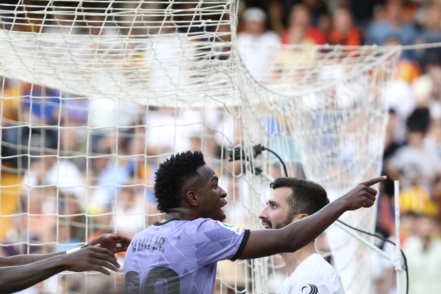 Real Madrid's Vinicius Junior, center, reacts as he points to someone in the crowd during a Spanish La Liga soccer match between Valencia and Real Madrid, at the Mestalla stadium in Valencia, Spain, Sunday, May 21, 2023. (AP Photo/Alberto Saiz)