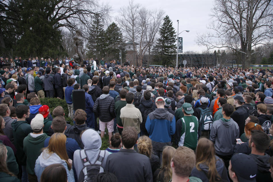 A crowd gathered around the Sparty statue on Michigan State University's campus listens as Miles Bridges and men's basketball coach Tom Izzo speak during an NCAA college basketball news conference, Thursday, April 13, 2017, in East Lansing, Mich. Bridges, a 6-foot-7 forward from Flint, Mich., announced he is returning for his sophomore season. (AP Photo/Al Goldis)