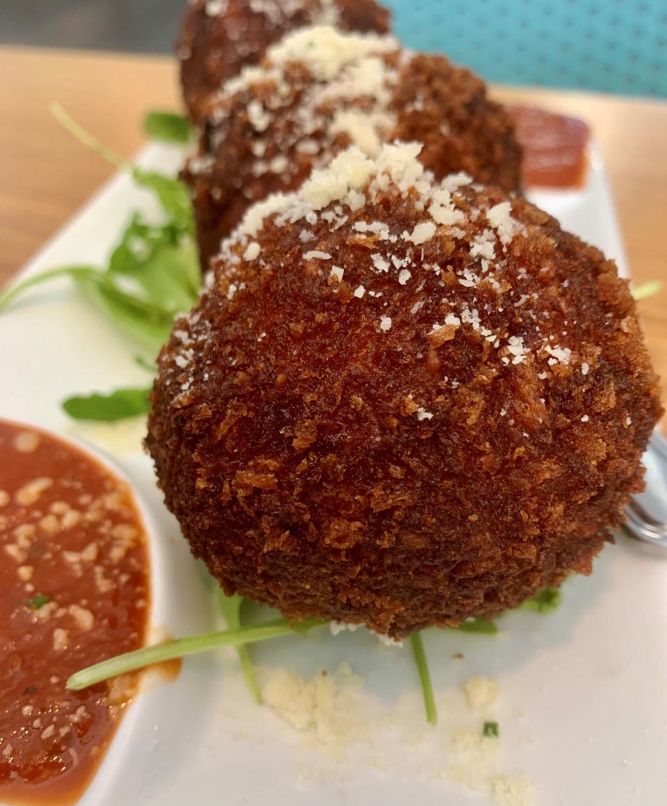 The arancini at Station 49 in Palm Bay are large, with a crispy coating that retains no oily flavor, stuffed with rice and cheese.