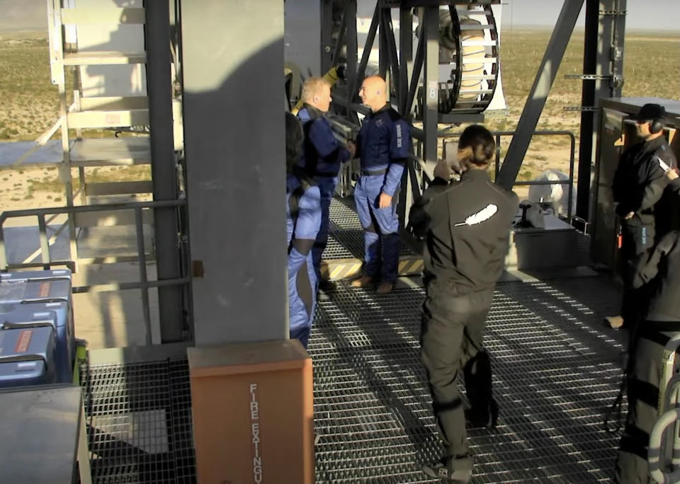 William Shatner shakes hands with Jeff Bezos before entering the Blue Origin spacecraft. - Credit: Blue Origin