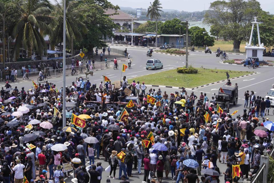 Anti Government protesters shout slogans outside the Galle International Cricket Stadium during the second day of the second test cricket match between Australia and Sri Lanka in Galle, Sri Lanka, Saturday, July 9, 2022. (AP Photo/Eranga Jayawardena)