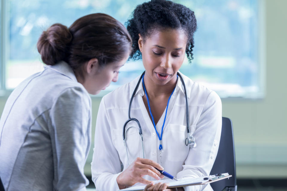 A physician assistant talking to anther woman