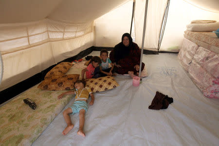 Displaced Iraqi people, who fled from the Islamic State violence, sit inside a tent at Debaga Camp in the Makhmour area near Mosul, Iraq, August 30, 2016. REUTERS/Azad Lashkari