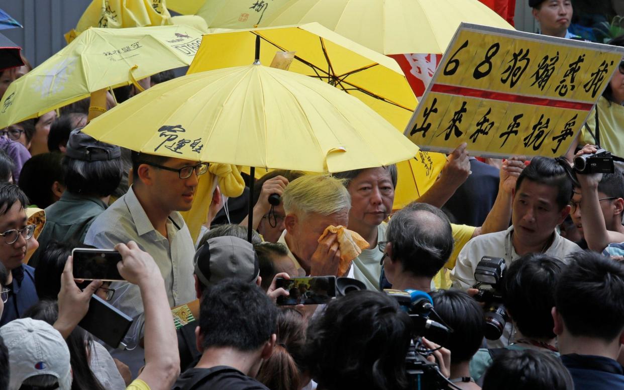 Occupy Central leader Chu Yiu-ming cried as he spoke to the media after sentencing on Wednesday - AP