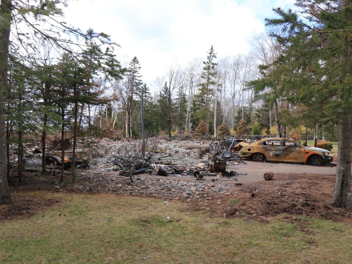 The burned-out remains of the Nova Scotia mass shooter's cottage on Portapique Beach Road in Portapique, N.S., taken May 13, 2020. RCMP knew of three complaints within three years about the gunman's weapons, threats and behaviour, but no search warrants for the property were ever requested. (Steve Lawrence/CBC - image credit)