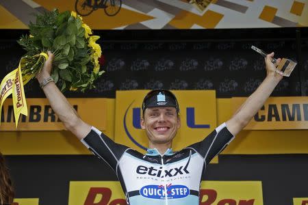 Etixx-Quick Step rider Tony Martin of Germany celebrates on the podium after winning the 223.5-km (138.9 miles) 4th stage of the 102nd Tour de France cycling race from Seraing in Belgium, to Cambrai, France, July 7, 2015. REUTERS/Eric Gaillard