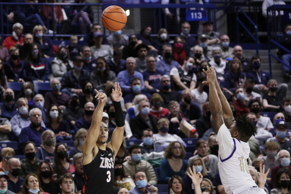 Gonzaga guard Andrew Nembhard, left, shoots in front of Alcorn State guard Paul King during the second half of an NCAA college basketball game, Monday, Nov. 15, 2021, in Spokane, Wash. (AP Photo/Young Kwak)