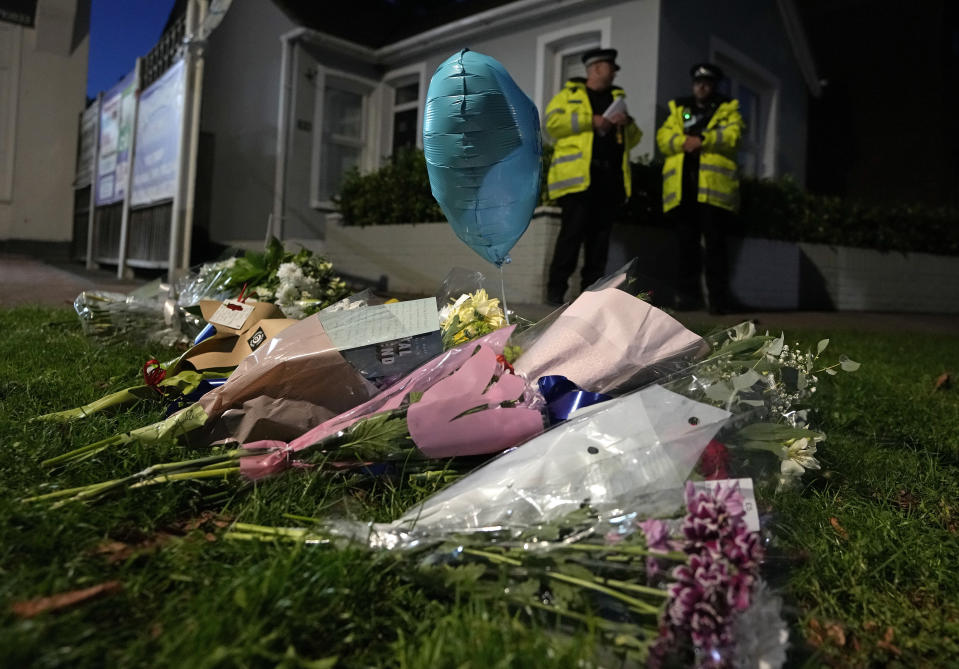 Floral tributes are placed on one of the roads leading to the Belfairs Methodist Church in Eastwood Road North, where British Conservative lawmaker David Amess has died after being stabbed at a constituency surgery, in Leigh-on-Sea, Essex, England, Friday, Oct. 15, 2021. Police gave no immediate details on the motive for the killing of 69-year-old Conservative lawmaker Amess and did not identify the suspect, who was being held on suspicion of murder. (AP Photo/Kirsty Wigglesworth)