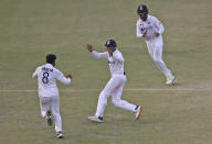 India's Ravindra Jadeja, left, celebrates the wicket of New Zealand's Tim Southee with his teammates during the day five of their first test cricket match in Kanpur, India, Monday, Nov. 29, 2021. (AP Photo/Altaf Qadri)