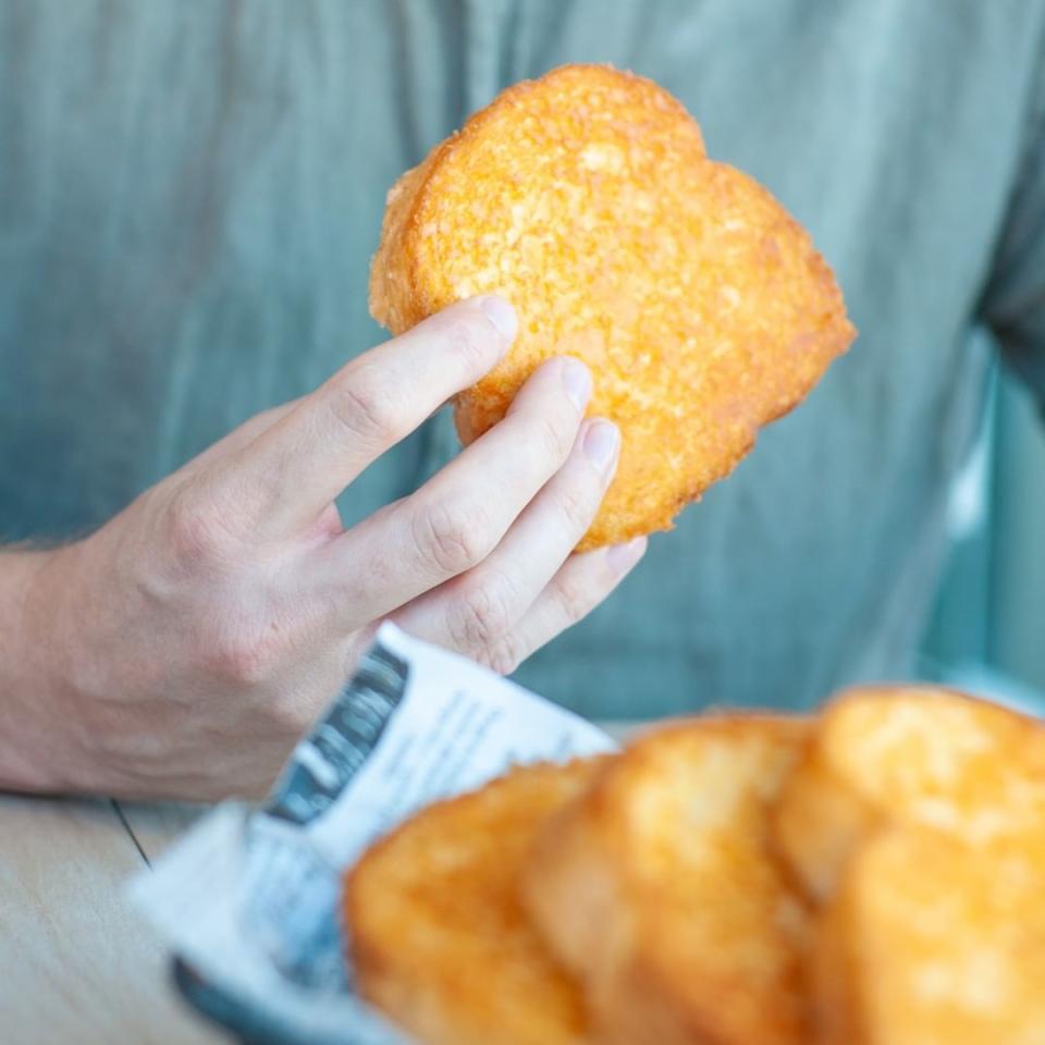 Man holding Sizzler cheese toast