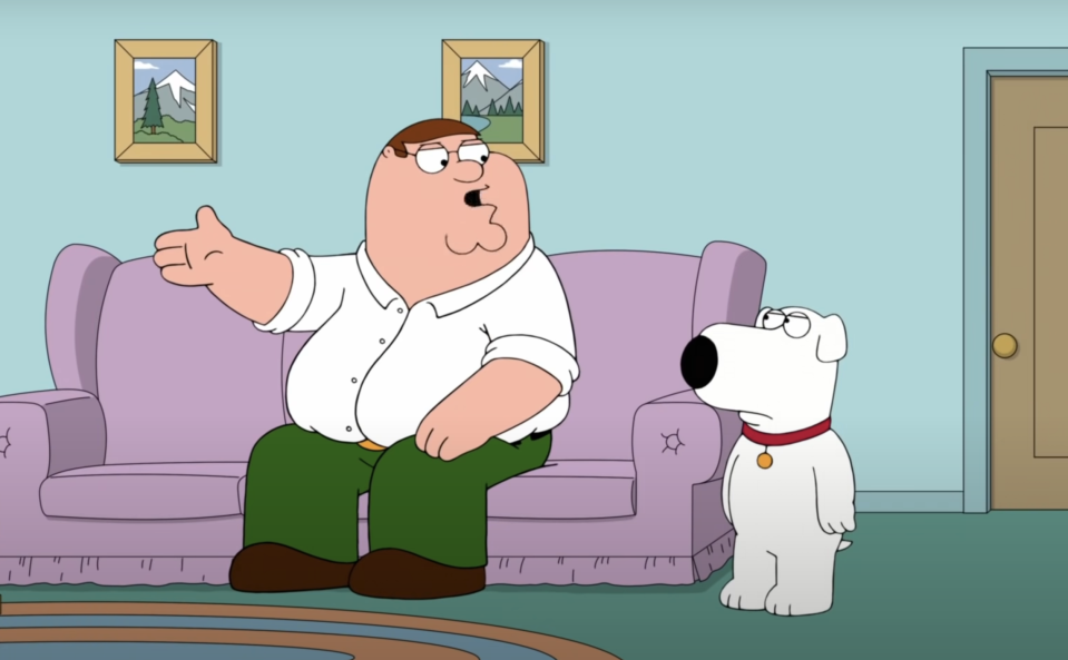 Peter Griffin and Brian Griffin from Family Guy are sitting on a couch in a living room; Peter is gesturing with his hand while talking to Brian