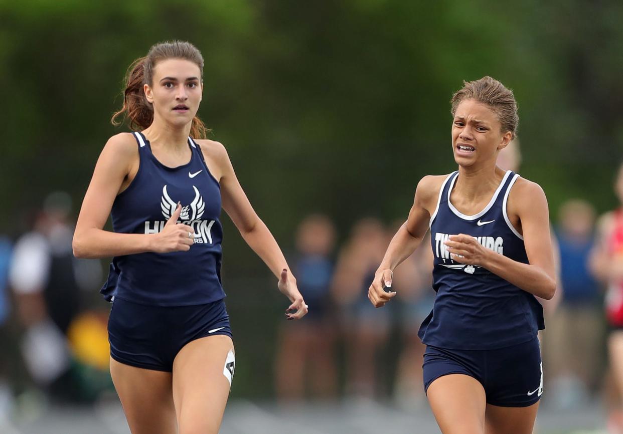 Twinsburg's Sophia Besett, right, passes Hudson's Lauren Pacsi to narrowly win the girls 400 meter dash during the Division I district track meet at Nordonia High School on Friday.