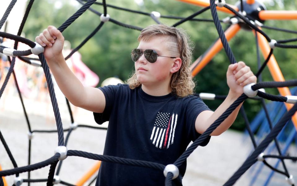 Max Weihbrecht, 13, of the Town of Lawrence, is pictured on Aug. 3, 2022, outside Hemlock Creek Elementary School in the Town of Lawrence, Wis. Weihbrecht is a finalist in the 2022 USA Mullet Championships.