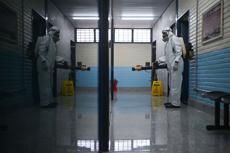 Un trabajador del sector de la salud fumiga contra el mosquito transmisor del dengue Aedes aegypti en una escuela de la región administrativa de Ceilandia en Brasilia