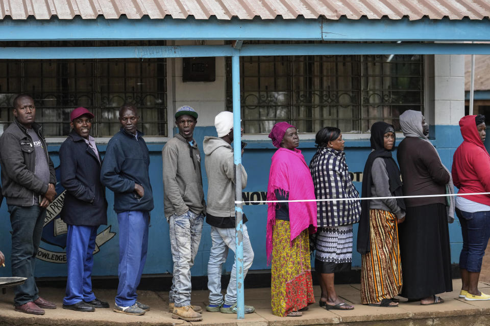 People line up to vote at the Kibera Primary School in Nairobi, Kenya, Tuesday, Aug. 9, 2022. Polls opened Tuesday in Kenya's unusual presidential election, where a longtime opposition leader who is backed by the outgoing president faces the deputy president who styles himself as the outsider. (AP Photo/Mosa'ab Elshamy)
