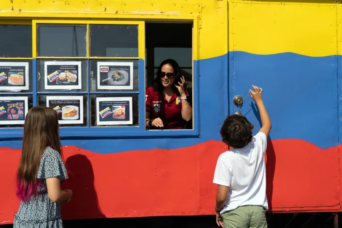 Erika Rojas and her children at her food truck in Tallahassee, Fla., on March 30, 2023. (Malcolm Jackson/The New York Times)