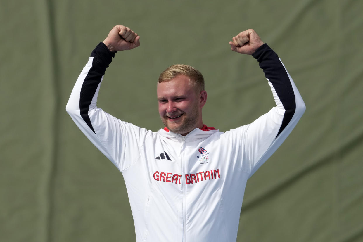 Britain's Nathan Hales celebrates after winning the gold medal in the Trap men's final at the 2024 Summer Olympics, Tuesday, July 30, 2024, in Chateauroux, France. (AP Photo/Manish Swarup)