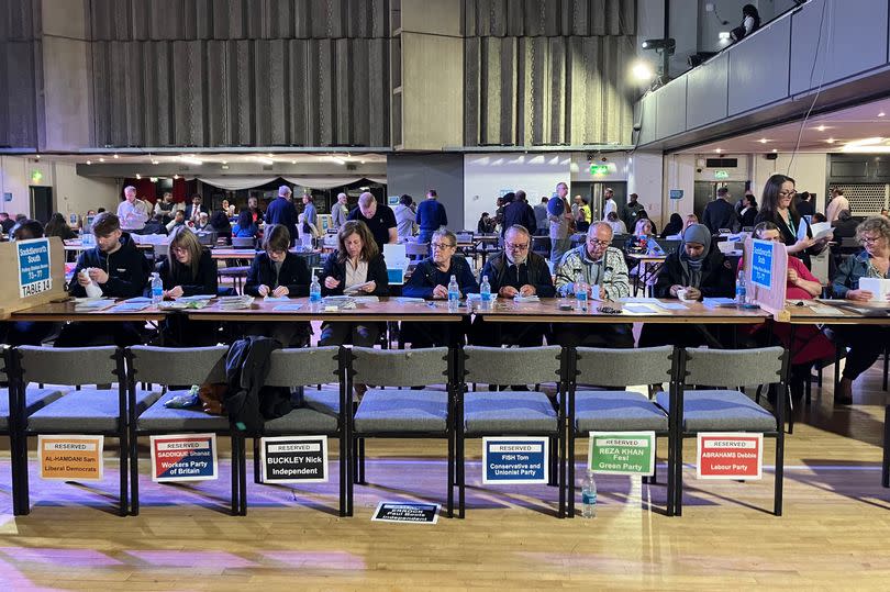 Counters going through ballots for the Oldham East constituency.