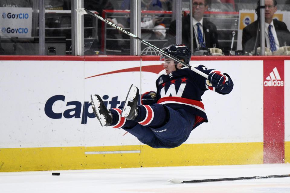 Washington Capitals right wing Nicolas Aube-Kubel gets airborne during the second period of an NHL hockey game against the New York Islanders, Monday, April 10, 2023, in Washington. (AP Photo/Nick Wass)