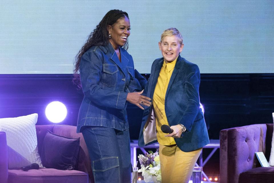 Former first lady Michelle Obama greets Ellen DeGenereson stage as she launches her new book “The Light We Carry: Overcoming in Uncertain Times.” at Warner Theater in Washington, Tuesday, Nov.15, 2022. ( AP Photo/Jose Luis Magana)