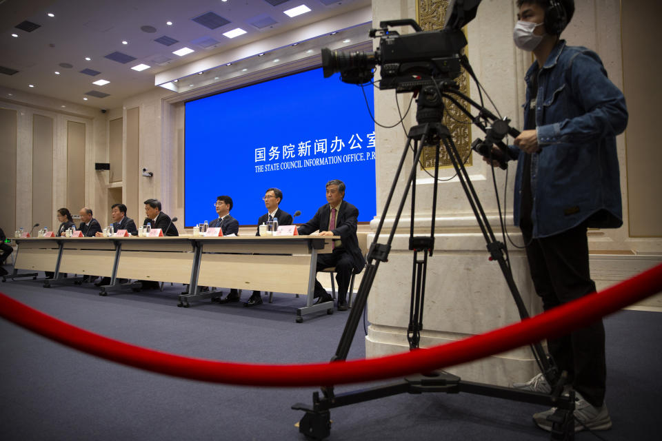 Chinese health officials attend a press conference held to discuss COVID-19 vaccine-related issues at the State Council Information Office in Beijing, Friday, Sept. 25, 2020. A Chinese health official said Friday that the country's annual production capacity for COVID-19 vaccines will top 1-billion next year, following an aggressive government support program for new factories. (AP Photo/Mark Schiefelbein)