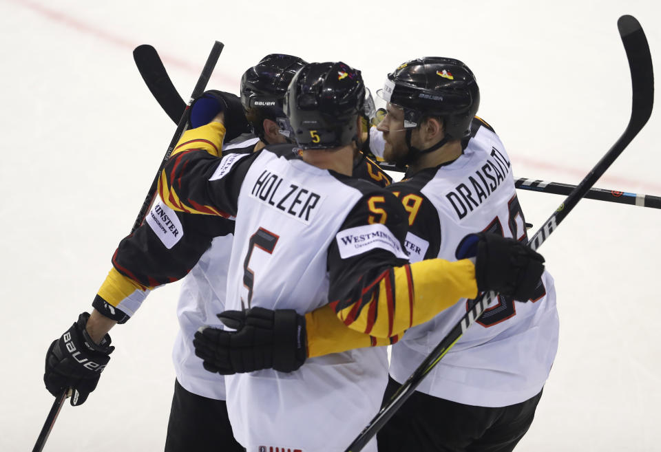 Germany's Leon Draisaitl, right, celebrates with teammates after scoring his sides fourth goal during the Ice Hockey World Championships group A match between Germany and Finland at the Steel Arena in Kosice, Slovakia, Tuesday, May 21, 2019. (AP Photo/Petr David Josek)