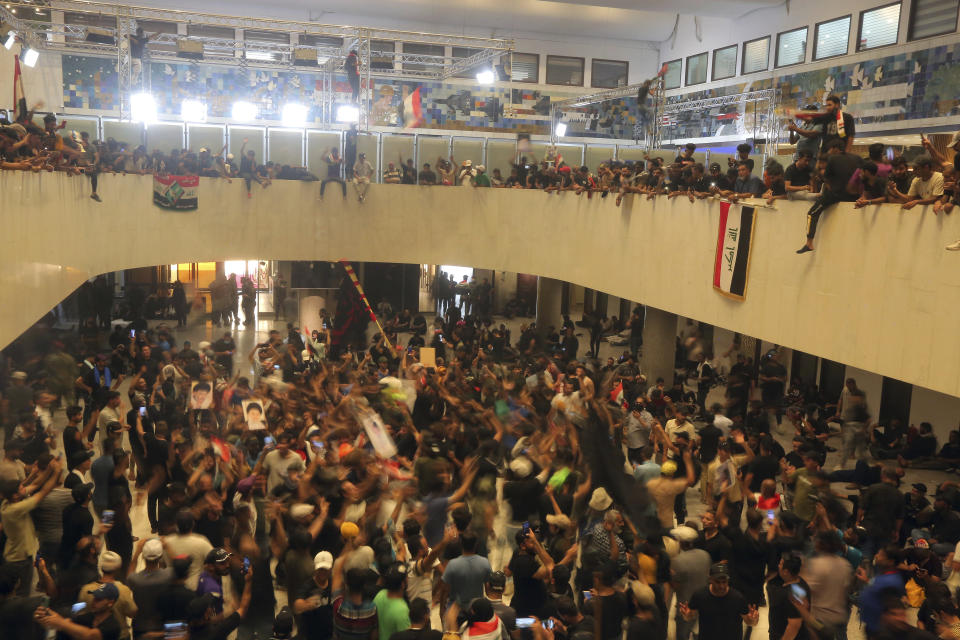 Iraqi protesters fill the Parliament building in Baghdad, Iraq, Saturday, July 30, 2022 as thousands of followers of an influential Shiite cleric breached the building for the second time in a week to protest the government formation efforts lead by Iran-backed groups.(AP Photo/Anmar Khalil)