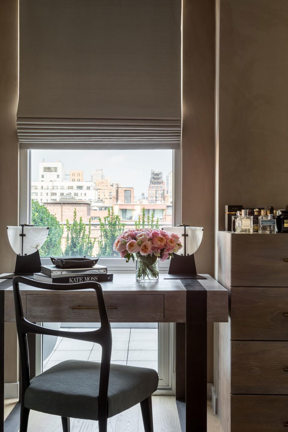 A discreet desk area in the dressing room is topped with vintage Pierre Chareau lamps and created by Edition Modern in Los Angeles.