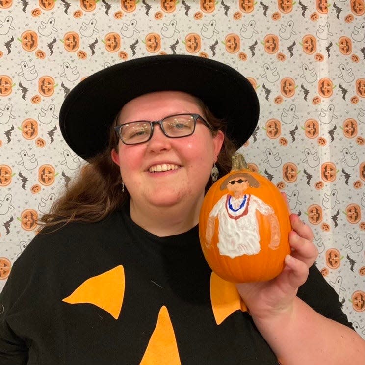 Sara Brown holds up a pumpkin that she painted the lead singer of Greta Van Fleet, Josh Kiszka, at the Purdue University Department of Human Development and Family Science pumpkin paint event in October 2021.