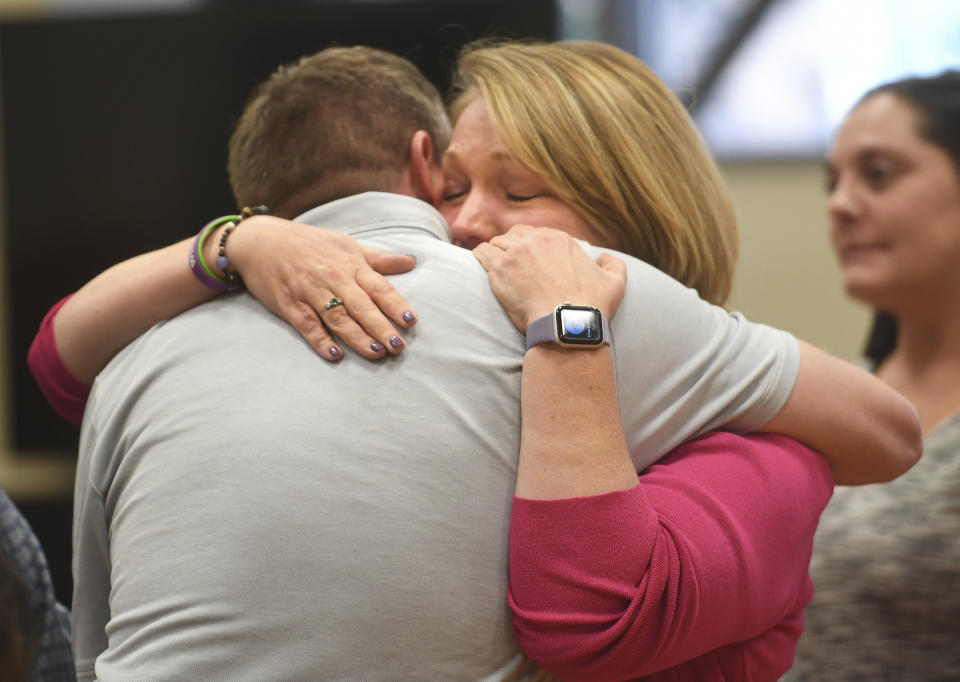 Plaintiffs Robbie Parker, left, and Nicole Hockley hug following the reading of the jury awards for damages in the Alex Jones defamation trial at Superior Court, Wednesday, Oct. 12, 2022, in Waterbury, Conn. A six-person jury reached a verdict Wednesday, saying that Jones should pay $965 million to 15 plaintiffs who suffered from his lies about the Sandy Hook school massacre. Jones and his company were found liable for damages last year. (Brian A. Pounds/Hearst Connecticut Media via AP, Pool)