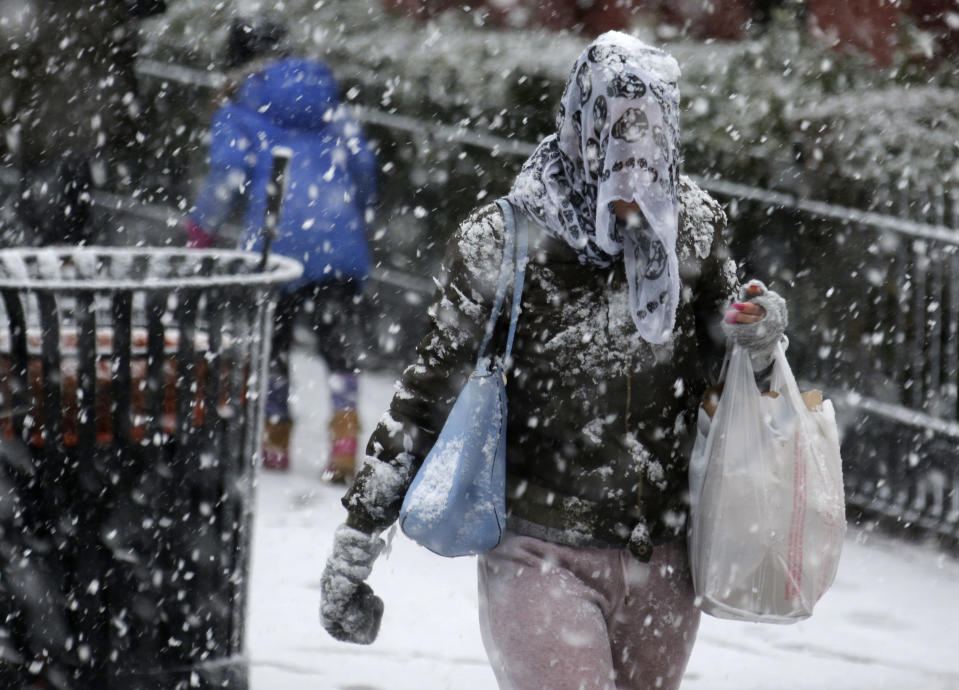 <p>A woman wears a scarf over her head to keep the snow off in Hoboken, N.J., March 7, 2018. New Jersey and the New York metro area got another winter storm just days after a nor’easter hammered the region with high winds. (Photo: Seth Wenig/AP) </p>