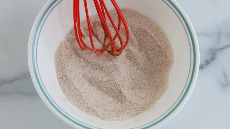 whisking sugar and spices in bowl